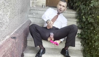 Kinky gentleman slave spread legs and plays with his ass in a car in public