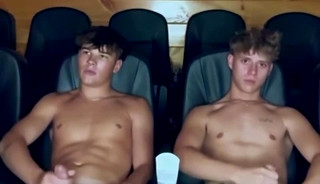 Two guys masturbating in a movie theater.