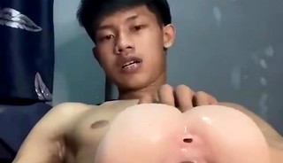 Thai boy jerking off with a toy alone