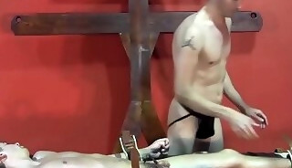 Submissive young gay restrained to be whipped and tormented