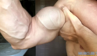 Young Muscle Hunk with Flexes Big Biceps